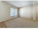 Bright living room featuring neutral walls, carpet, with natural light, offering a comfortable and versatile living space at 5818 Butterfield St, Riverview, FL 33578