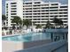 Community swimming pool with tropical landscaping in the background at 5915 Sea Ranch Dr # 403, Hudson, FL 34667