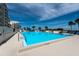 Large community pool on a sunny day surrounded by tropical landscaping at 5915 Sea Ranch Dr # 403, Hudson, FL 34667