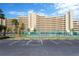 Enjoy a game on the tennis court located near a luxurious apartment building on a sunny day at 5915 Sea Ranch Dr # 403, Hudson, FL 34667