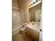 Cozy bathroom with shower-tub combo, tiled floors, and a vanity with mirror at 6002 Osprey Lake Cir, Riverview, FL 33578