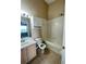 Cozy bathroom featuring a shower-tub combo and a vanity with sink at 6002 Osprey Lake Cir, Riverview, FL 33578