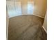 Carpeted bedroom with doors and natural light at 6002 Osprey Lake Cir, Riverview, FL 33578