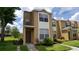 Inviting two-story townhouse featuring a well-maintained lawn and classic architectural details at 6002 Osprey Lake Cir, Riverview, FL 33578
