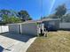 Exterior view of a building in the backyard with painted concrete and an open doorway in a grassy yard at 645 38Th S Ave, St Petersburg, FL 33705