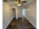 Bedroom with laminate flooring, ceiling fan, closet, and light-colored walls at 645 38Th S Ave, St Petersburg, FL 33705