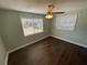 Cozy bedroom with wood-look flooring and natural light coming through the windows at 645 38Th S Ave, St Petersburg, FL 33705