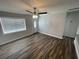 Bright living room with modern ceiling fan, wood-look flooring and a glass adorned front door at 645 38Th S Ave, St Petersburg, FL 33705