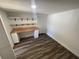 Office space with built-in desk, shelves, and laminate floors at 645 38Th S Ave, St Petersburg, FL 33705