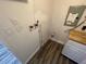 Utility area with plumbing, electrical box, and laminate floors at 645 38Th S Ave, St Petersburg, FL 33705