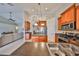 Open concept kitchen featuring brown cabinets, an island, and stainless steel appliances at 7708 Nottinghill Sky Dr, Apollo Beach, FL 33572