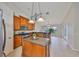 Well-lit kitchen with stainless appliances, a functional island, and an adjacent breakfast nook at 7708 Nottinghill Sky Dr, Apollo Beach, FL 33572