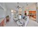 Bright living room features neutral colors, tile flooring, and an open floor plan to the kitchen at 7708 Nottinghill Sky Dr, Apollo Beach, FL 33572