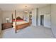 Large main bedroom showcases a four poster bed, en suite bath, and walk-in closet at 7708 Nottinghill Sky Dr, Apollo Beach, FL 33572