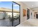 Hallway leading to an outdoor patio, featuring sliding glass doors and marble floors at 8235 Dunham Station Dr, Tampa, FL 33647