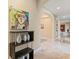 Hallway featuring arched doorways, marble floors, and decorative artwork at 8235 Dunham Station Dr, Tampa, FL 33647