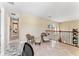 Upstairs hallway featuring comfortable seating, a desk, and railing overlooking the main level at 8235 Dunham Station Dr, Tampa, FL 33647