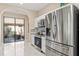 Modern kitchen featuring stainless steel appliances, white cabinets, and a view of the outdoor patio at 8235 Dunham Station Dr, Tampa, FL 33647