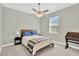 Relaxing bedroom with a cozy ceiling fan, complemented by natural light from a nearby window at 860 17Th S Ave, St Petersburg, FL 33701
