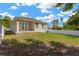 Exterior home view showcasing a well-maintained lawn, French doors, and a white fence for privacy, creating a serene outdoor space at 860 17Th S Ave, St Petersburg, FL 33701