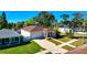 Charming home featuring a lush lawn, brick driveway, and a convenient attached garage for easy access and curb appeal at 860 17Th S Ave, St Petersburg, FL 33701