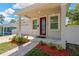 Charming home featuring a red front door, brick walkway, and well-maintained landscaping at 860 17Th S Ave, St Petersburg, FL 33701