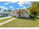 A cozy single-Gathering home showcases a well-kept lawn, a brick driveway, and an attached garage at 860 17Th S Ave, St Petersburg, FL 33701