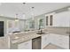Kitchen with stainless steel appliances, marble countertops, and white cabinets at 860 17Th S Ave, St Petersburg, FL 33701
