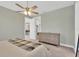 A comfortably carpeted main bedroom featuring a ceiling fan and a view towards the home's common areas at 860 17Th S Ave, St Petersburg, FL 33701