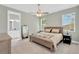 Cozy main bedroom showcasing neutral tones, a ceiling fan, and an en-suite bathroom at 860 17Th S Ave, St Petersburg, FL 33701