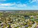 This aerial view shows a neighborhood with single Gathering homes and ponds with mature trees and landscaping at 8621 Bridgewater Dr, New Port Richey, FL 34655