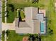 An aerial view of a home with a screened pool, lovely backyard landscaping and brick-paved driveway at 8621 Bridgewater Dr, New Port Richey, FL 34655