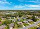 A neighborhood of single-Gathering homes is shown in this aerial view with mature trees and green grass at 8621 Bridgewater Dr, New Port Richey, FL 34655