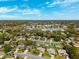 An aerial view of a neighborhood featuring single Gathering homes, mature trees, parks, and shopping areas at 8621 Bridgewater Dr, New Port Richey, FL 34655