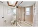 Bright bathroom with a tile-surround bathtub and shower and white toilet and vanity at 8621 Bridgewater Dr, New Port Richey, FL 34655