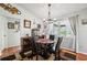 Charming dining room featuring hardwood floors, modern lighting, and a view of the outdoors through a window at 8621 Bridgewater Dr, New Port Richey, FL 34655