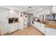 Well-lit kitchen featuring white appliances, tile flooring, and ample cabinet storage at 8621 Bridgewater Dr, New Port Richey, FL 34655