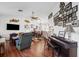 Spacious living room featuring hardwood floors, comfortable seating, a piano, and a modern television at 8621 Bridgewater Dr, New Port Richey, FL 34655