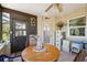 Cozy sunroom features a quaint table and chairs, providing a relaxing spot with natural light and access to the outdoors at 8621 Bridgewater Dr, New Port Richey, FL 34655