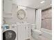 Well-lit bathroom with combo shower and washer-dryer hookups at 10423 Carrollbrook Cir # 102, Tampa, FL 33618