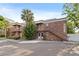 Two-story brick building with palm trees, exterior stairs, and sidewalk at 10423 Carrollbrook Cir # 102, Tampa, FL 33618