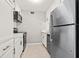 Modern kitchen featuring stainless steel appliances, white cabinets, and tile flooring at 10423 Carrollbrook Cir # 102, Tampa, FL 33618