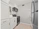 Modern kitchen featuring stainless steel appliances, white cabinets, and tile flooring at 10423 Carrollbrook Cir # 102, Tampa, FL 33618