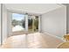 Bright room with large sliding doors to a lake view and tile flooring at 10423 Carrollbrook Cir # 102, Tampa, FL 33618