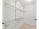 Walk-in closet with built-in shelving and tile flooring at 10423 Carrollbrook Cir # 102, Tampa, FL 33618