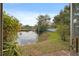 Relaxing lake view from the property, showcasing lush greenery lining the banks and serene water reflecting the sky at 10423 Carrollbrook Cir # 102, Tampa, FL 33618