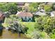 Aerial view of the property shows the backyard, wooded area, and proximity to the pond at 10906 Johanna Ave, Riverview, FL 33578