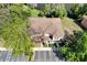Aerial view of the house shows roofline, trees, and parking area from above on a sunny day at 10906 Johanna Ave, Riverview, FL 33578