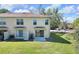 Backyard view with lawn, small patio, and townhouse-style architecture at 10906 Johanna Ave, Riverview, FL 33578