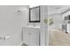 Half-bathroom with modern vanity, framed mirror, and neutral paint located off the main living area at 10906 Johanna Ave, Riverview, FL 33578